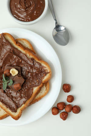 Concept of delicious food with chocolate paste on white background