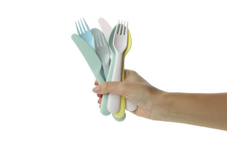 Female hand holds cutlery, isolated on white background