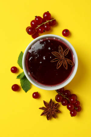 Cranberry sauce and ingredients on yellow backgroundの写真素材