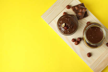 Concept of delicious food with chocolate paste on yellow backgroundの写真素材