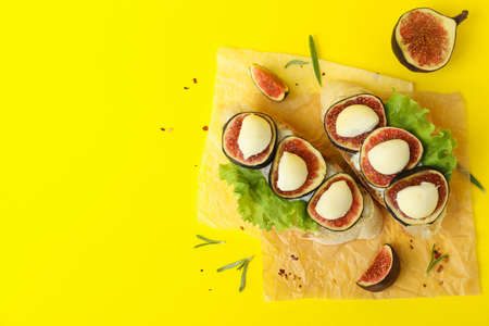 Tasty bruschetta with fig on yellow backgroundの写真素材