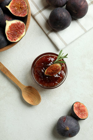 Concept of tasty food with fig jam on white textured backgroundの写真素材