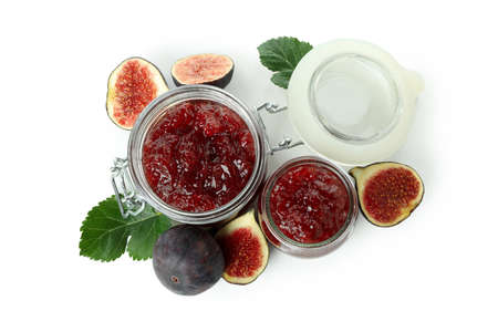 Jars with fig jam and ingredients isolated on white backgroundの写真素材