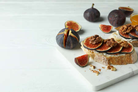 Concept of tasty food with bruschetta with fig on white wooden tableの写真素材