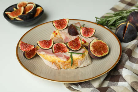 Concept of tasty food with bruschetta with fig on white backgroundの写真素材