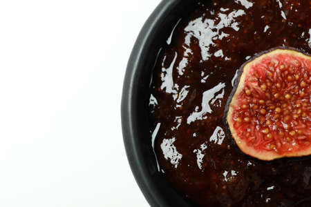 Bowl with fig jam and slice on white backgroundの写真素材