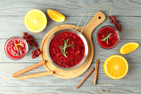 Cranberry sauce and ingredients on gray wooden tableの写真素材