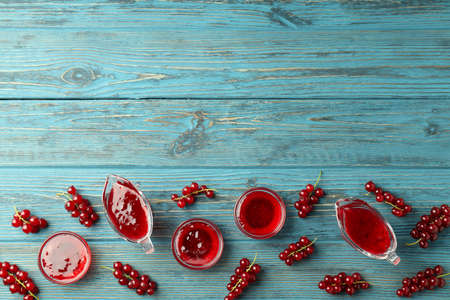 Bowls with cranberry sauce and ingredients on wooden backgroundの写真素材