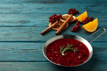 Cranberry sauce and ingredients on wooden backgroundの写真素材
