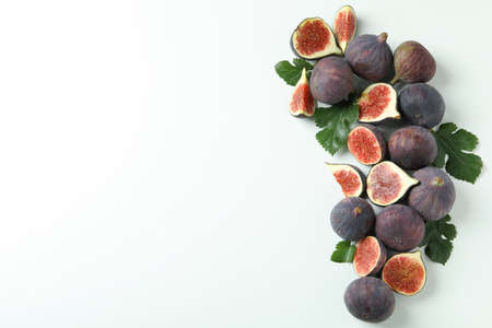Fig with leaves on white background, space for text