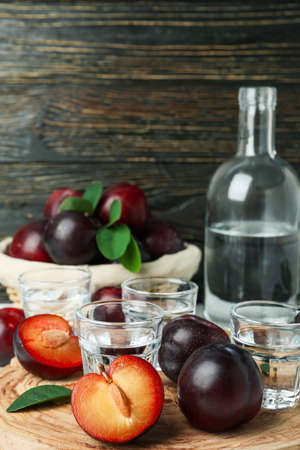 Concept of alcohol with plum vodka against wooden backgroundの写真素材