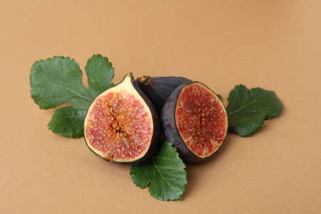 Fig with leaves on brown background, close upの写真素材