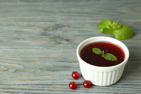 Bowl of cranberry sauce on gray wooden backgroundの写真素材