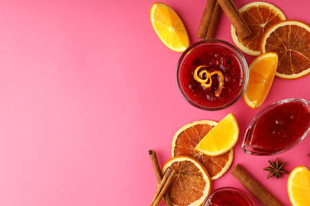 Cranberry sauce and ingredients on pink background