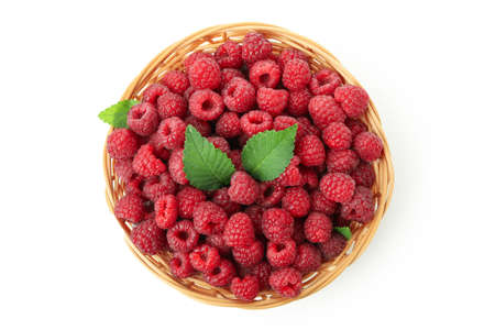 Red juicy raspberries in wicker vase, isolated on white background.