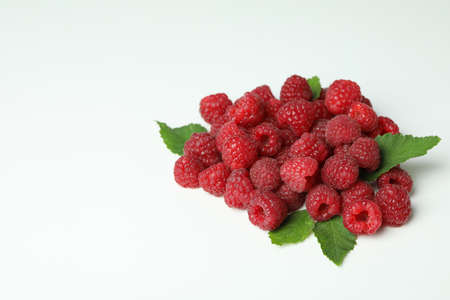A handful of red juicy raspberries on a white background, close up.