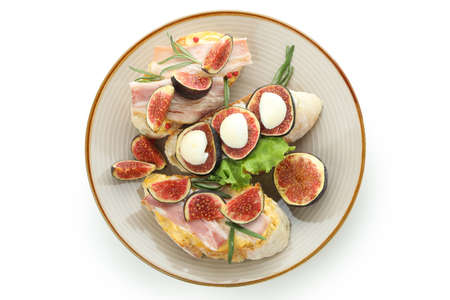 Plate with bruschetta with fig isolated on white backgroundの写真素材