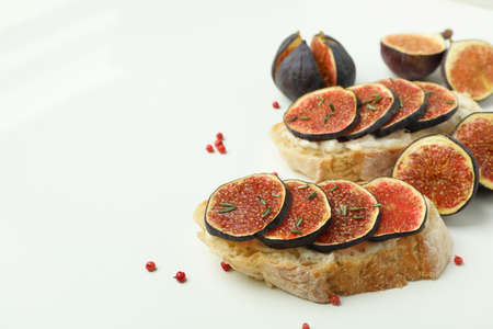 Tasty bruschetta with fig on white backgroundの写真素材