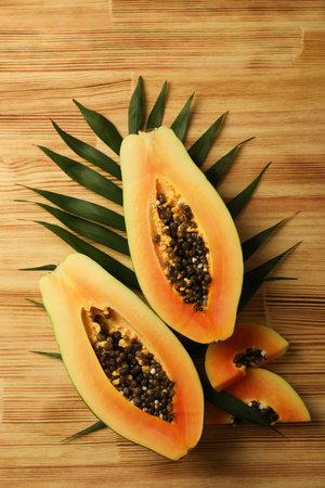 Ripe papaya with leaves on wooden backgroundの写真素材