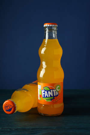 Odessa, Ukraine - September 23, 2021: Fanta bottles on wooden table against blue backgroundのeditorial素材