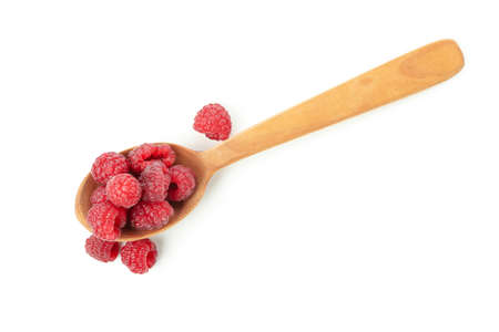 Wooden spoon with raspberries, isolated on white background.の写真素材