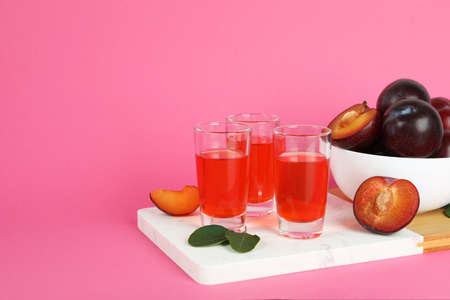 Plum brandy shots and ingredients on pink backgroundの写真素材