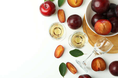 Plum vodka shots and ingredients on white backgroundの写真素材