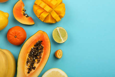 Exotic fruits set on blue background, space for text.の写真素材