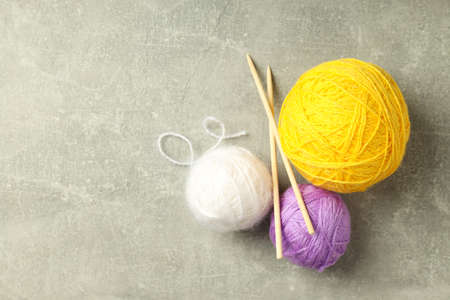 Yarn balls and knitting needles on light gray backgroundの写真素材