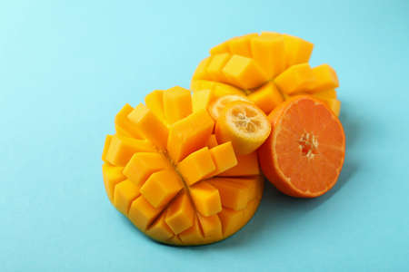 Ripe mango and orange on blue background.の写真素材