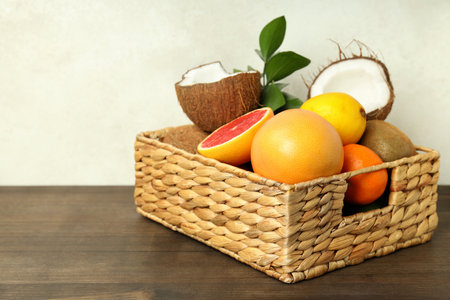 Basket with exotic fruits on wooden table.の写真素材