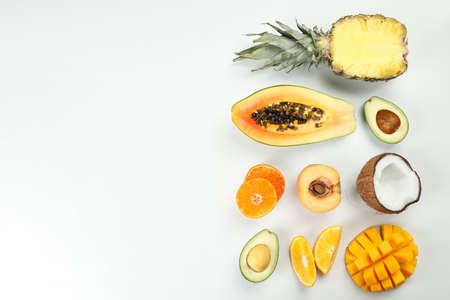 Exotic fruits on white background, space for text.
