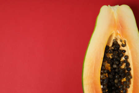 Half of ripe papaya on red backgroundの写真素材