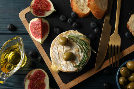 Concept of tasty food with grilled camembert on wooden background.の写真素材