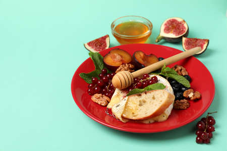 Concept of tasty food with grilled camembert on mint background.の写真素材