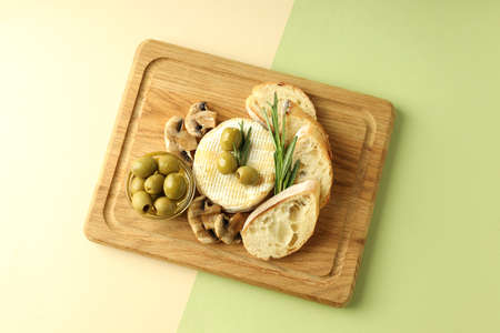 Concept of tasty food with grilled camembert on two tone background.の写真素材