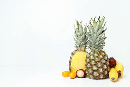 Exotic fruits on white background, space for text ..