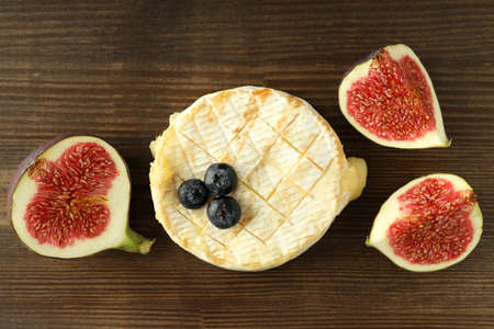 Concept of tasty food with grilled camembert on wooden background.の写真素材
