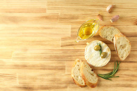 Concept of tasty food with grilled camembert on wooden background.の写真素材
