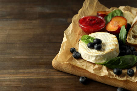 Concept of tasty food with grilled camembert on wooden background.の写真素材