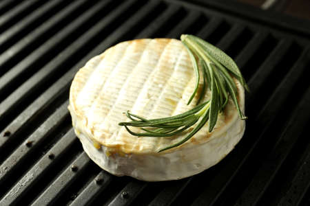 Grilled camembert on electric grill, close up.の写真素材