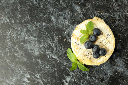 Tasty grilled camembert on black smokey background.の写真素材