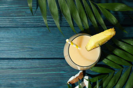 Pina colada cocktail on blue wooden table.の写真素材