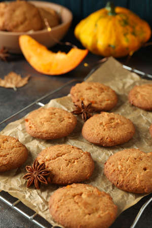 Concept of tasty food with pumpkin cookies on dark textured background.の写真素材