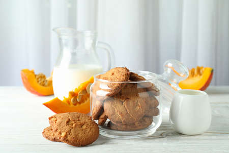 Concept of tasty food with pumpkin cookies on white wooden table.の写真素材