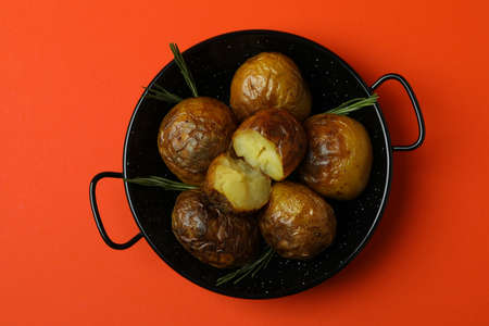 Bowl with baked potato on orange background.の写真素材