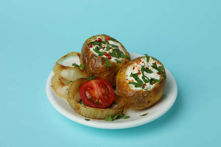 Plate with baked potato on blue background.の写真素材