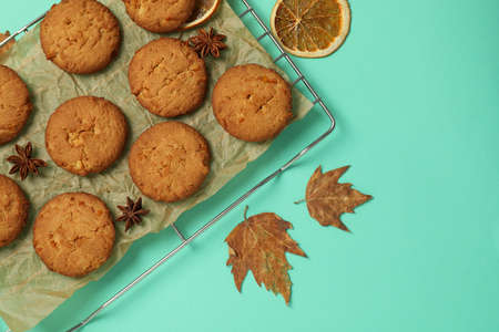 Concept of tasty food with pumpkin cookies on mint background.の写真素材