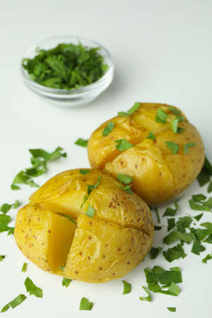 Baked potato with parsley on white background.の写真素材