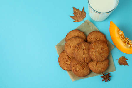 Milk and pumpkin cookies on blue background.の写真素材